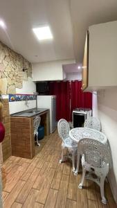 a kitchen with a table and chairs and a counter at Pousada Apart Fraga Maia in Feira de Santana +30 photos