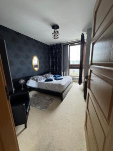 a bedroom with a bed and a chair and a window at Sea Towers in Gdynia