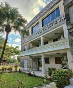a building with a palm tree in front of it at Condumel in Cozumel +42 photos