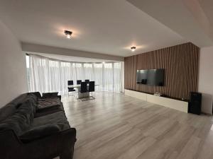 a living room with a couch and a flat screen tv at Luxury 3 Bedroom Pool Villa in Gulia
