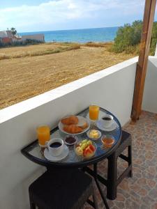 a tray of breakfast food on a table on a balcony at DANAI'S Sea Whisper in Lékhaion