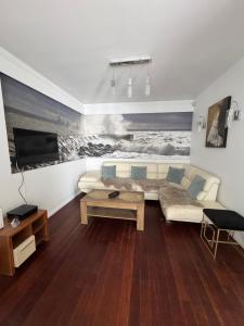 a living room with a couch and a tv at Sea Towers in Gdynia