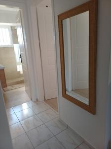 a mirror on a wall next to a hallway at DANAI'S Sea Whisper in Lékhaion +34 photos