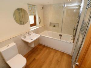 a bathroom with a toilet and a sink and a shower at Brynawelon in Newport +27 photos