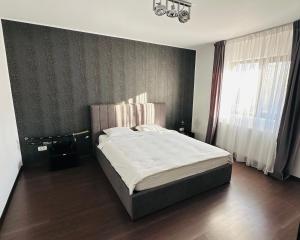 a bedroom with a bed and a large window at Luxury 3 Bedroom Pool Villa in Gulia +10 photos