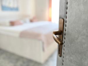 a close up of a metal door with a sink at Rab City Apartment Greeny in Rab