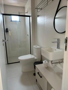 a bathroom with a toilet and a sink and a shower at Miraflores Hotel in Macapá +22 photos