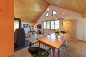 a kitchen and dining room with a table and chairs at Dachnest in Unterwasser