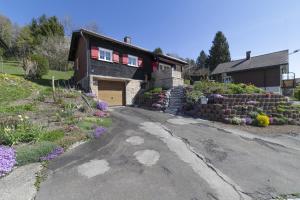 a driveway leading to a house with a garage at Bergpanorama in Wildhaus