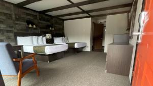 a hotel room with two beds and a desk at Adirondack Lodge Old Forge in Old Forge