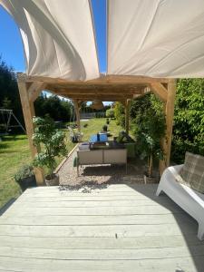 a pavilion with a table and a couch under it at Camping Abordaż Wolin in Kołczewo