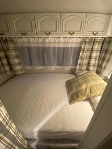 a bed in the back of a car with a pillow at Camping Abordaż Wolin in Kołczewo +6 photos