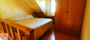 a small bedroom with a bed and a window at Duplex in Pinamar