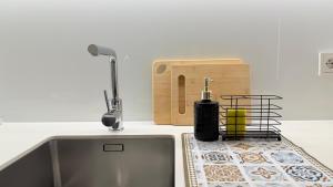 a kitchen counter with a sink and a faucet at Ruzop Apartament - Modern studio in center, self check-in, WiFi in Poznań +26 photos