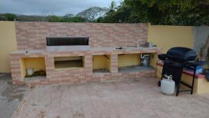 a brick fireplace with a tv on top of it at Hotel Rosangel in Estero Hondo