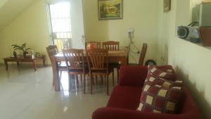 a living room with a couch and a table and chairs at Hotel Rosangel in Estero Hondo