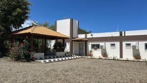 a building with a gazebo in front of it at Hotel Rosangel in Estero Hondo
