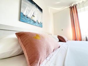 a bedroom with a bed with two pillows on it at Rab City Apartment Greeny in Rab