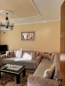 a living room with two couches and a table at Guest House Dimos Kristi in Përmet