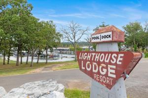 a sign for a lighthouse lodge in a park at Lighthouse Lodge 2 Lakefront Pool Boat Slip in Kimberling City +50 photos