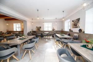a dining room with wooden tables and chairs at Hotel pod Kapličkou in Malá Morávka
