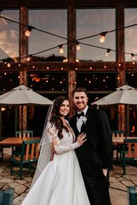 a bride and groom posing for a picture at their wedding at Echo Bluff State Park Lodge and Cabins in Eminence