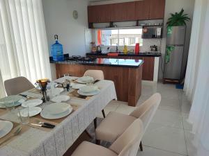 a kitchen with a table and chairs and a kitchen with a table and chairsktop at Casa Exclusiva Mar Adentro in Santa Cruz de la Sierra +3 photos
