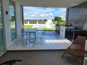 a patio with a table and stools on a balcony at Casa Exclusiva Mar Adentro in Santa Cruz de la Sierra