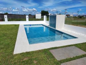 a swimming pool in the middle of a yard at Casa Exclusiva Mar Adentro in Santa Cruz de la Sierra