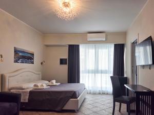 a bedroom with a bed and a table and chairs at The Gallery Rooms in Belvedere Marittimo