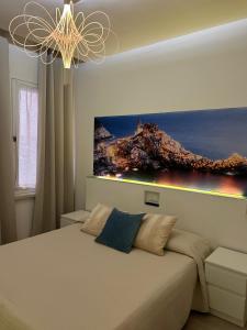 a bedroom with a bed with a painting on the wall at Suite Cinque terre Portovenere in La Spezia