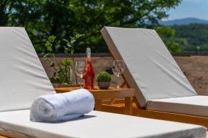 a table with two chairs and a bottle of wine at MB Villas in Vrnjačka Banja
