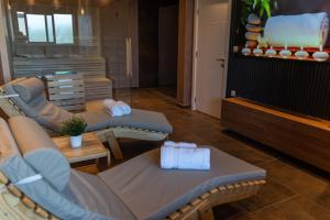 a living room with couches and a table with towels at MB Villas in Vrnjačka Banja +36 photos