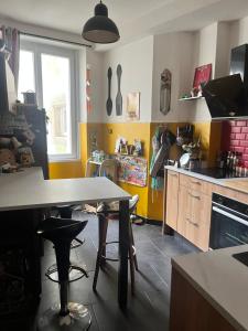 a kitchen with a table in the middle of it at Le5 Brest in Brest