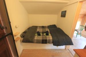 a bedroom with a bed with shoes on it at Forest Shed in Åsele