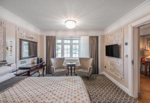 a bedroom with a bed and a desk and a television at Riverside Inn in Ely