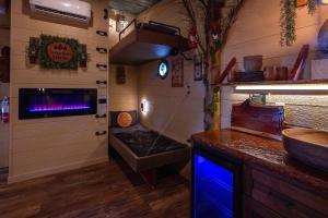a kitchen with a stove and a sink in a room at "Morning Wood" Luxury Treehouse Retreat Near Dollywood & Pigeon Forge in Sevierville