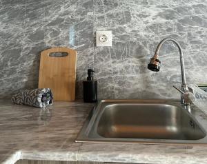 a kitchen counter with a sink and a knife at Liberty Home Μάκρη in Alexandroupoli