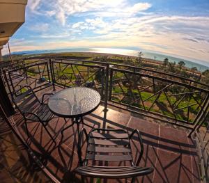 a table and chairs on a balcony with a view of the ocean at Hotel AnOrita in Kobuleti