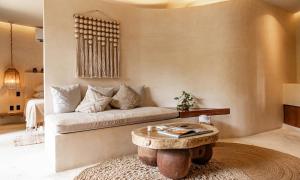 a living room with a couch and a coffee table at Taio Tulum in Tulum