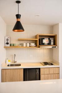 a kitchen with a sink and a microwave at Lago Verde Elit in Paipa