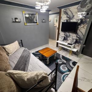 a living room with a couch and a tv at BEREA apartment 786 in Durban