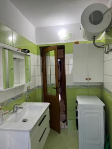 a bathroom with a sink and a mirror at Guest House Dimos Kristi in Përmet +24 photos