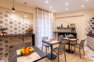 a dining room with two tables and chairs at Lotus B&B in Messina