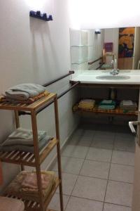 a bathroom with a sink and a counter with towels at kazAnne in Pointe-Noire +29 photos