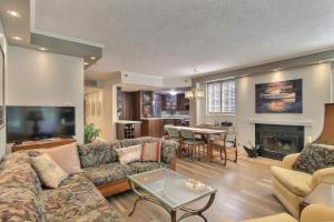 a living room with a couch and a table at Saint Sauveur Dream in Saint-Sauveur-des-Monts