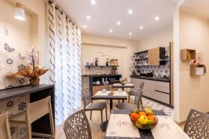 a kitchen and dining room with a table and chairs at Lotus B&B in Messina +55 photos