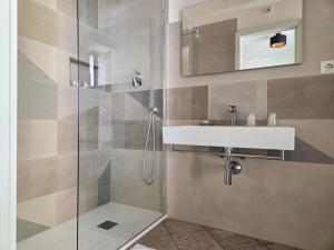 a bathroom with a sink and a shower at The Gallery Rooms in Belvedere Marittimo