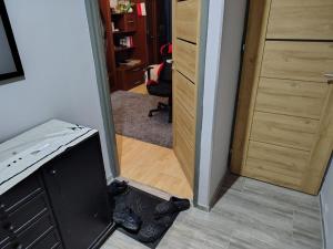 a hallway with a door leading into a room at Chelm Spoko Apartment in Chełm