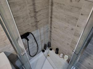 a bathroom with a shower with a bath tub at Chelm Spoko Apartment in Chełm